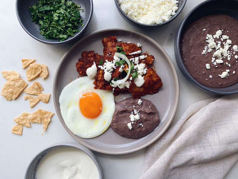 Chile Ancho Chilaquiles & Refried Black Beans By Karla Zazueta - banner image